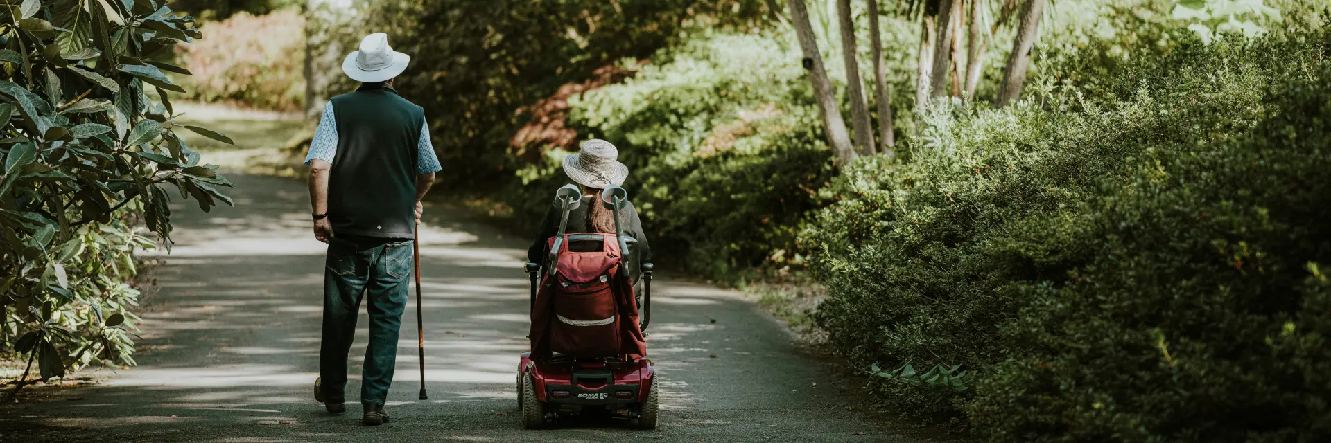 Personne marchant avec une canne et une autre en fauteuil roulant